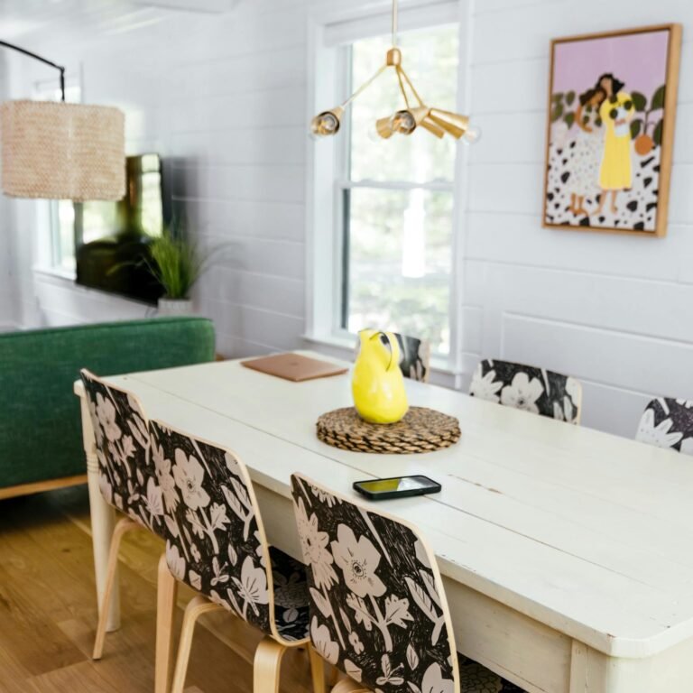 Contemporary dining room with floral chair design, vibrant decor, and modern artwork.