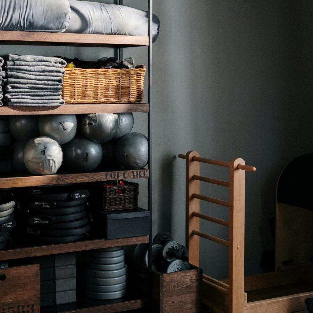 Neat arrangement of gym equipment and yoga mats in a modern fitness studio.